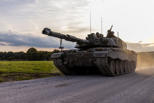 Tank rolling down a road